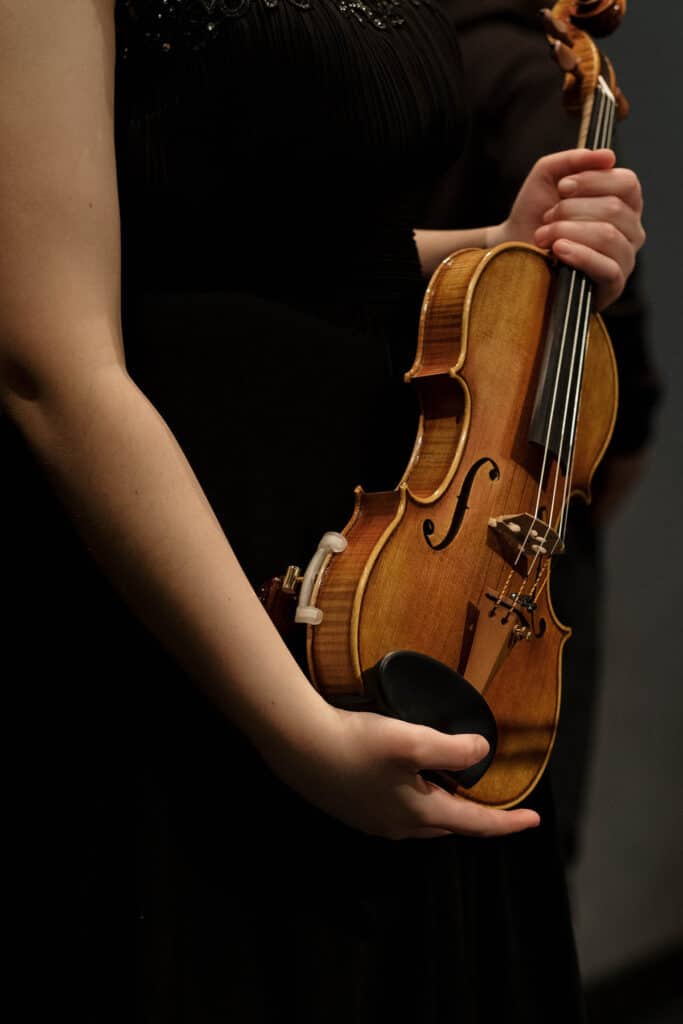 closeup of woman holding a violin